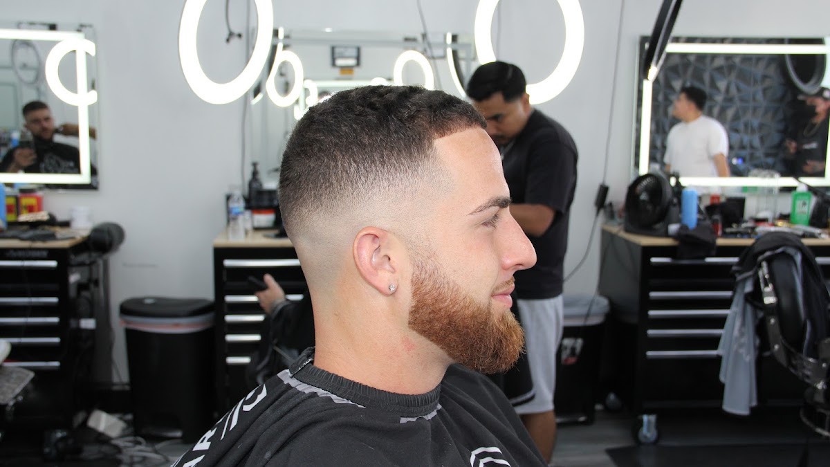 A finished skin fade with a shaped beard, seen in profile at Bushwick Barbershop
