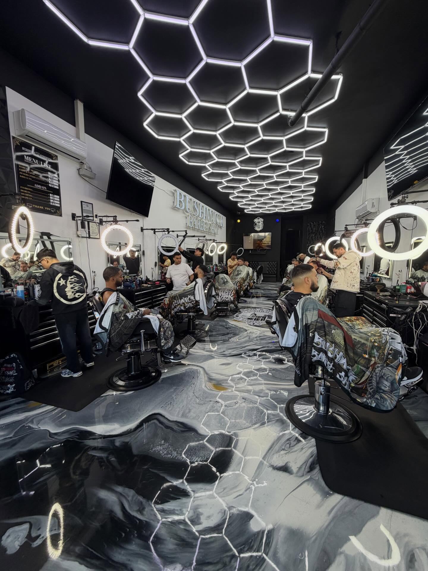 Every chair in Bushwick Barbershop occupied, barbers working under the hexagon lights