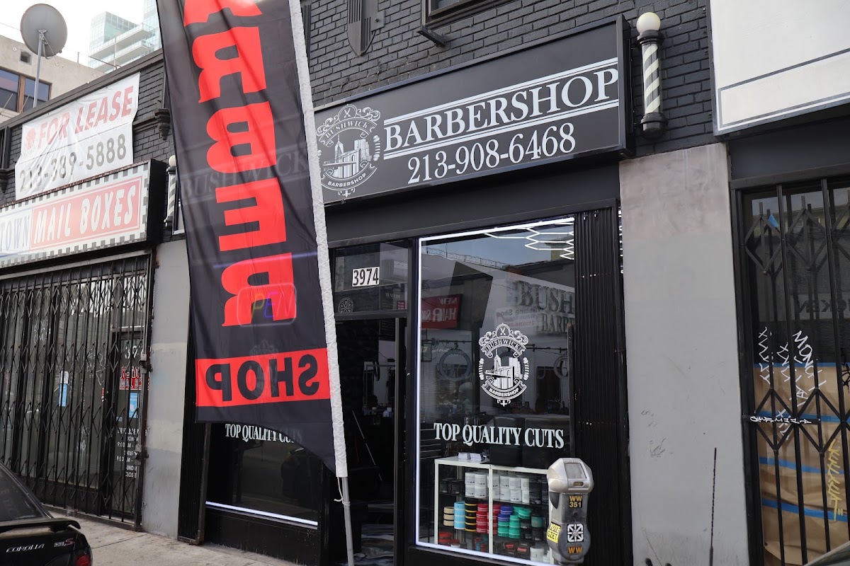Bushwick Barbershop storefront on West 6th Street with the barber pole and Top Quality Cuts on the glass